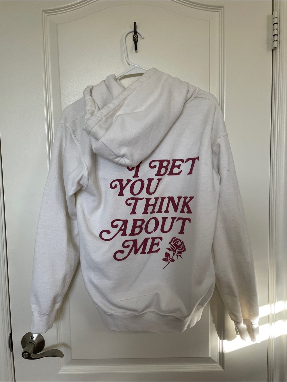 White Graphic Hoodie with Pink Script "I Bet You Think About Me"
